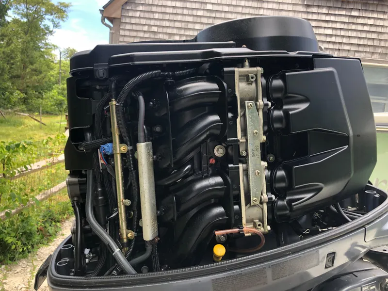 Slide: The Image of Close-up of a 2015 Parker 2530 Extended Cabin boat engine, showcasing intricate components. - 14