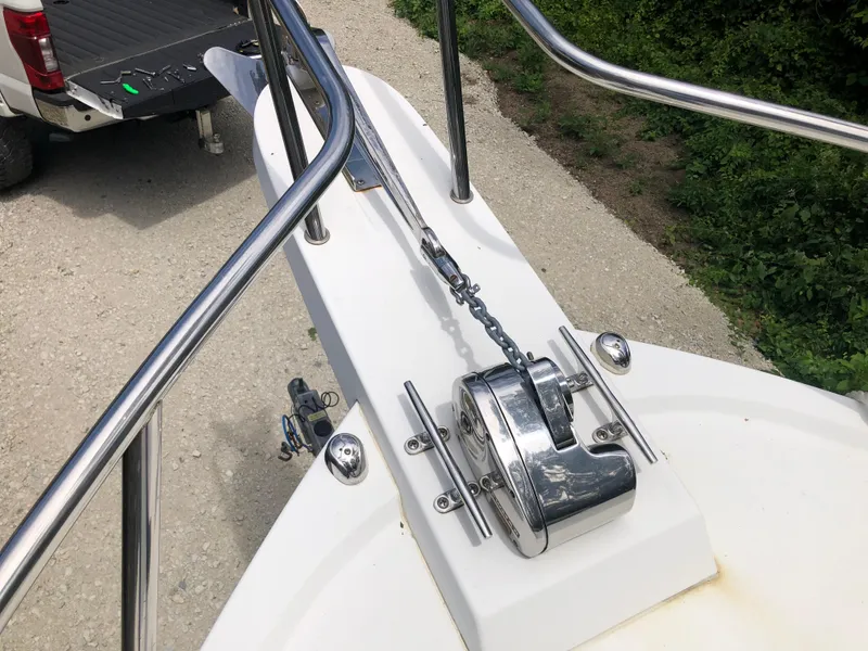 Slide: The Image of 2015 Parker 2530 Extended Cabin boat anchor system on deck, with truck in background. - 8