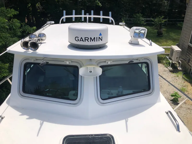 Slide: The Image of 2015 Parker 2530 Extended Cabin boat with Garmin radar and spotlight on deck. - 9