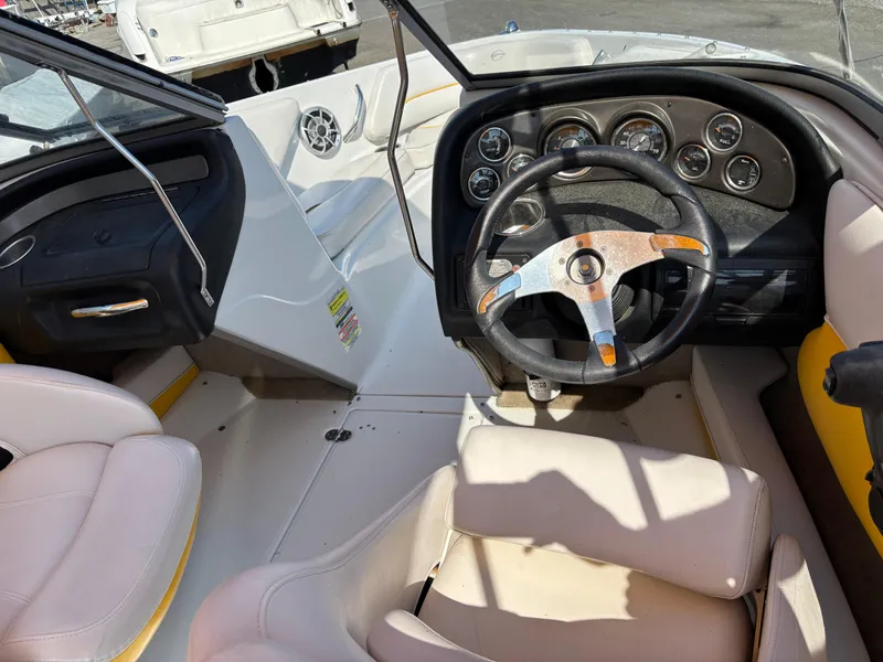 Slide: The Image of Interior of 2012 Crownline 185 SS boat showing steering wheel and dashboard controls. - 10