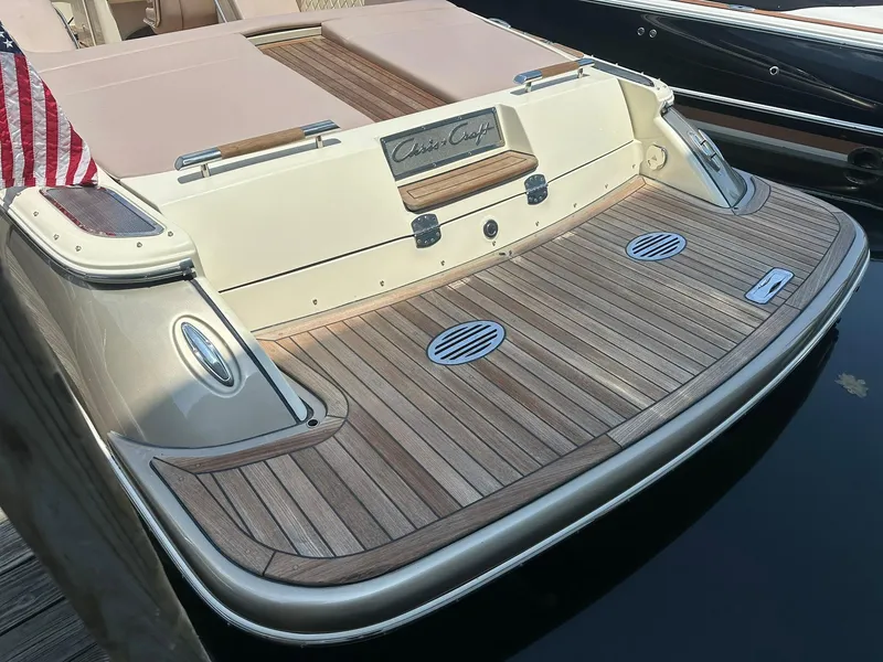 Slide: The Image of 2019 Chris-Craft Launch 30 boat with teak swim platform and American flag. - 10