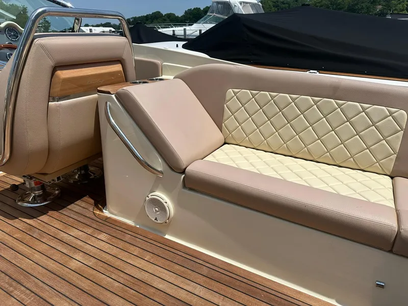Slide: The Image of 2019 Chris-Craft Launch 30 interior with beige leather seating and wooden deck. - 14