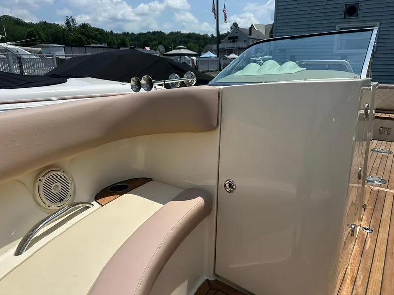 Slide: The Image of 2019 Chris-Craft Launch 30 interior with beige seating and wooden deck. - 21