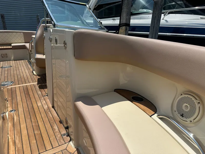 Slide: The Image of 2019 Chris-Craft Launch 30 interior with teak flooring and beige seating. - 22