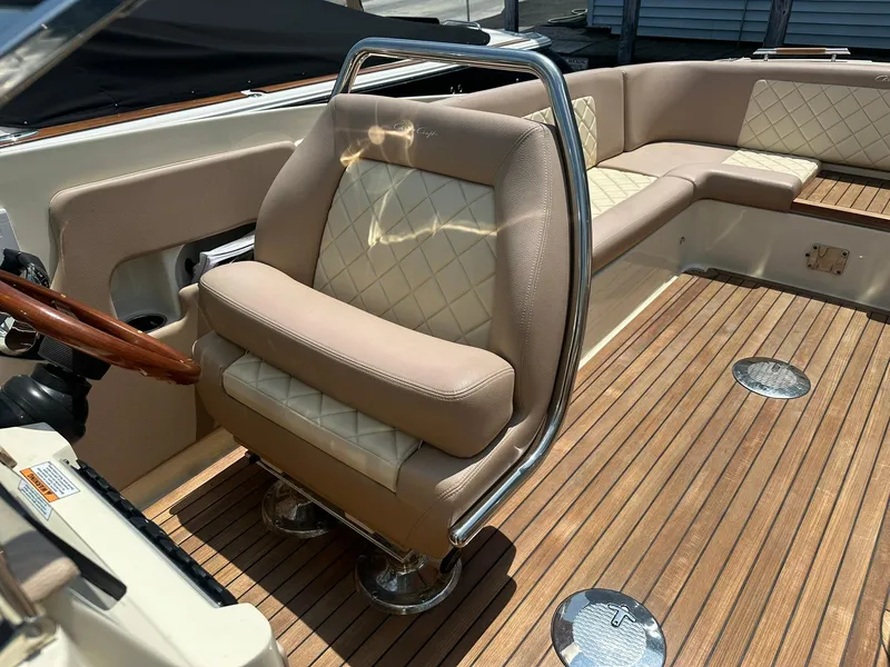 Slide: The Image of 2019 Chris-Craft Launch 30 interior with beige leather seating and wooden deck. - 24