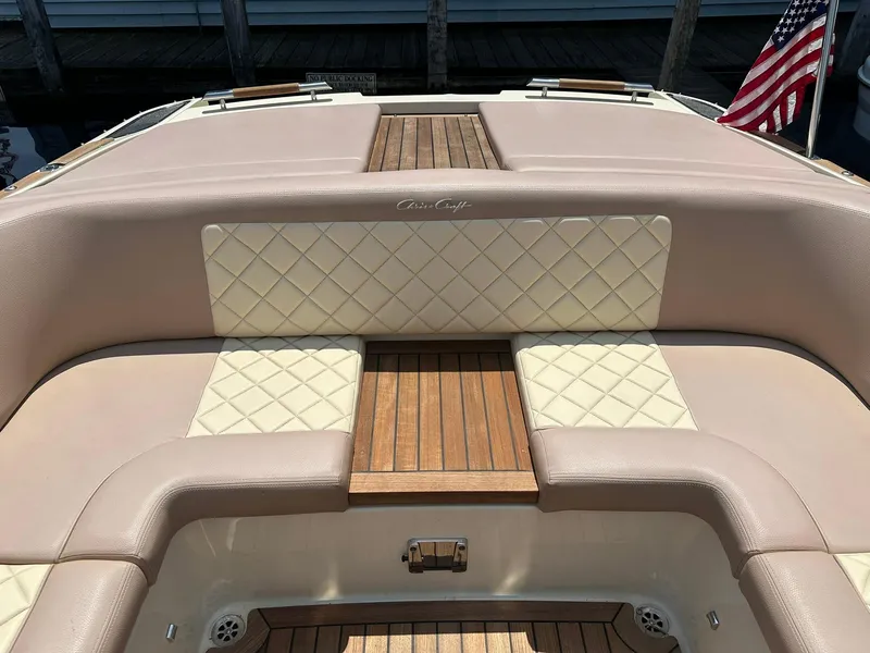 Slide: The Image of 2019 Chris-Craft Launch 30 boat interior with quilted seating and wooden deck. - 27