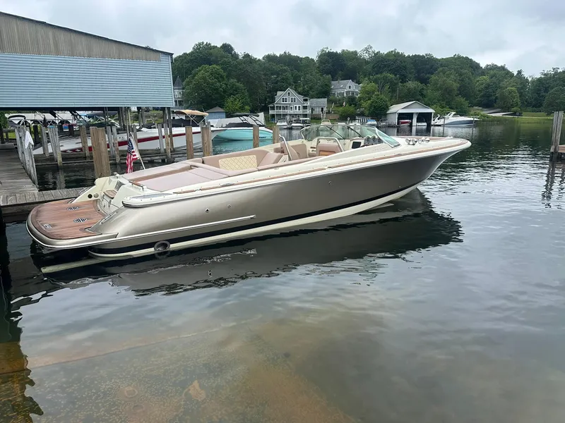 Slide: The Image of 2019 Chris-Craft Launch 30 boat docked on a serene lake with lush greenery. - 4