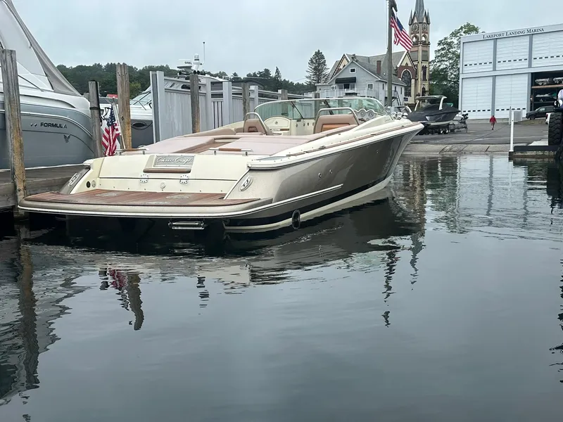 Slide: The Image of 2019 Chris-Craft Launch 30 boat docked at marina with American flag. - 7