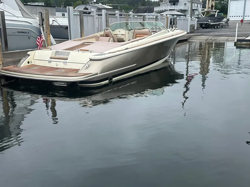 Slide: The Image of 2019 Chris-Craft Launch 30 boat docked at marina, calm water reflection. - 8