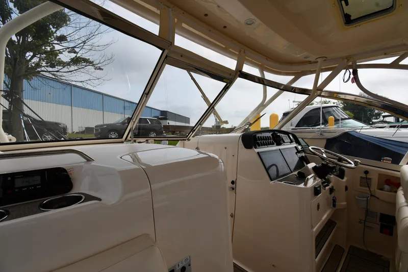 Slide: The Image of Interior view of 2018 Grady-White Freedom 335 boat, showcasing helm and dashboard controls. - 10