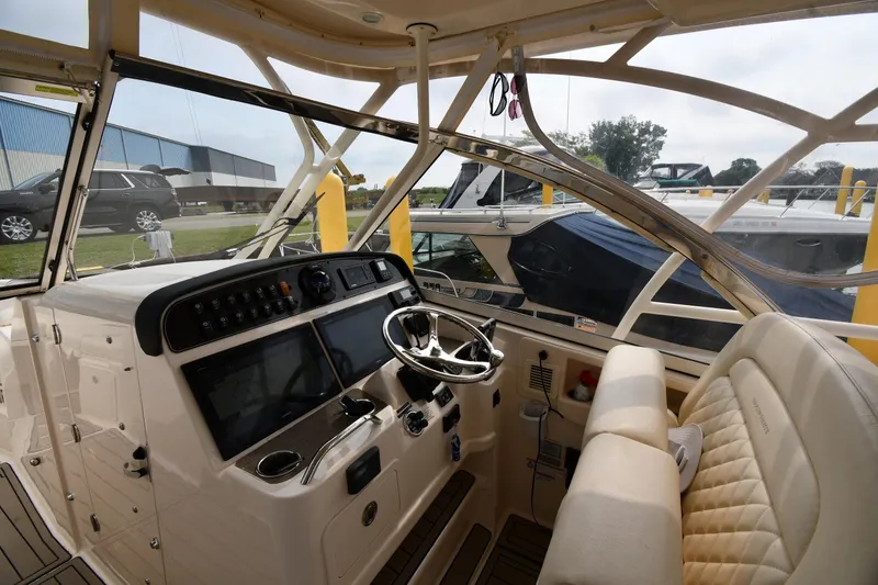 Slide: The Image of 2018 Grady-White Freedom 335 boat interior with steering wheel and dashboard controls. - 11