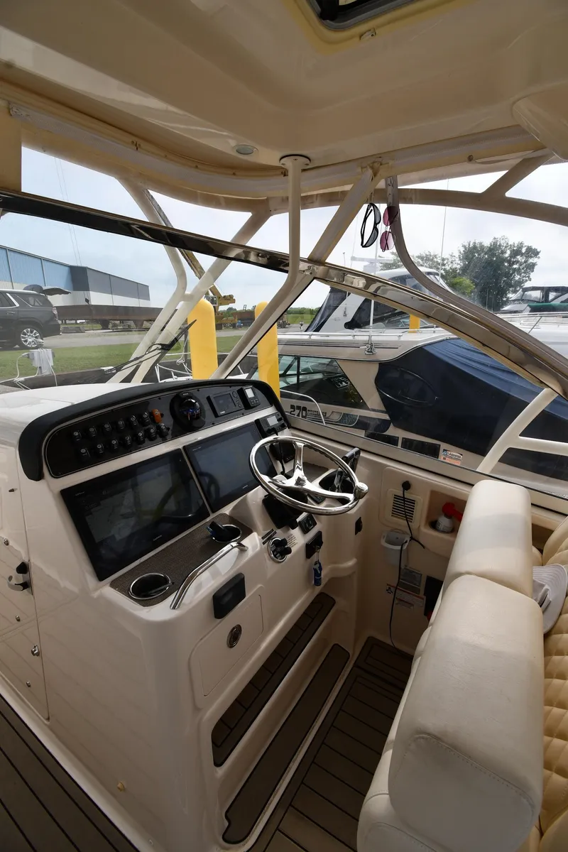 Slide: The Image of 2018 Grady-White Freedom 335 boat interior with steering wheel and control panel. - 12