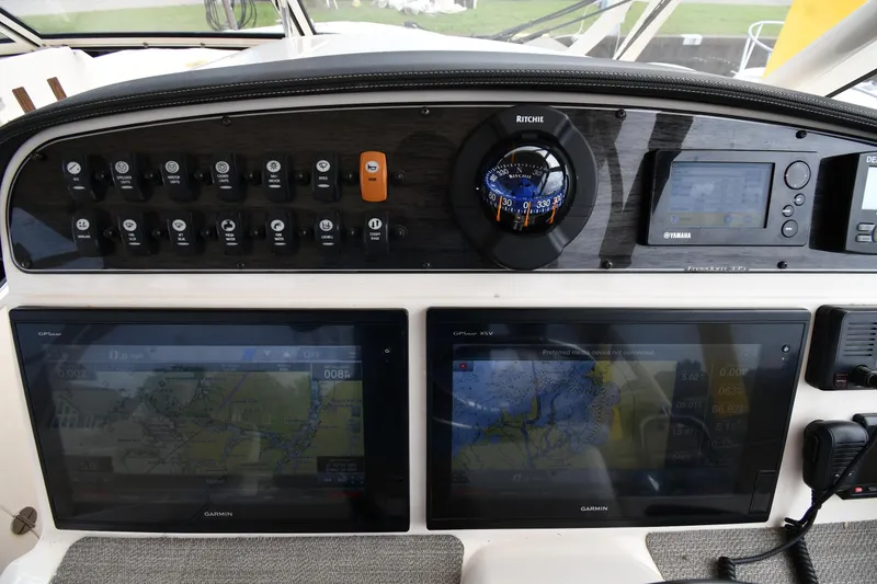Slide: The Image of Control panel of 2018 Grady-White Freedom 335 boat with navigation screens and switches. - 13