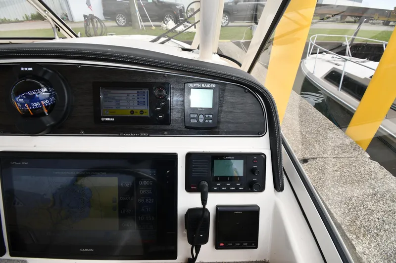 Slide: The Image of Control panel of 2018 Grady-White Freedom 335 boat with navigation instruments. - 14