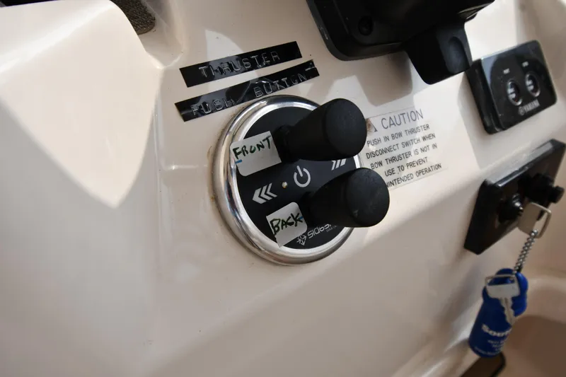 Slide: The Image of Control panel of 2018 Grady-White Freedom 335 boat with thruster buttons. - 17