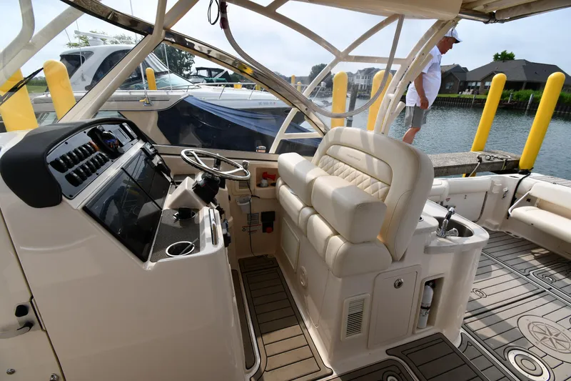 Slide: The Image of 2018 Grady-White Freedom 335 boat interior with helm and seating area. - 18