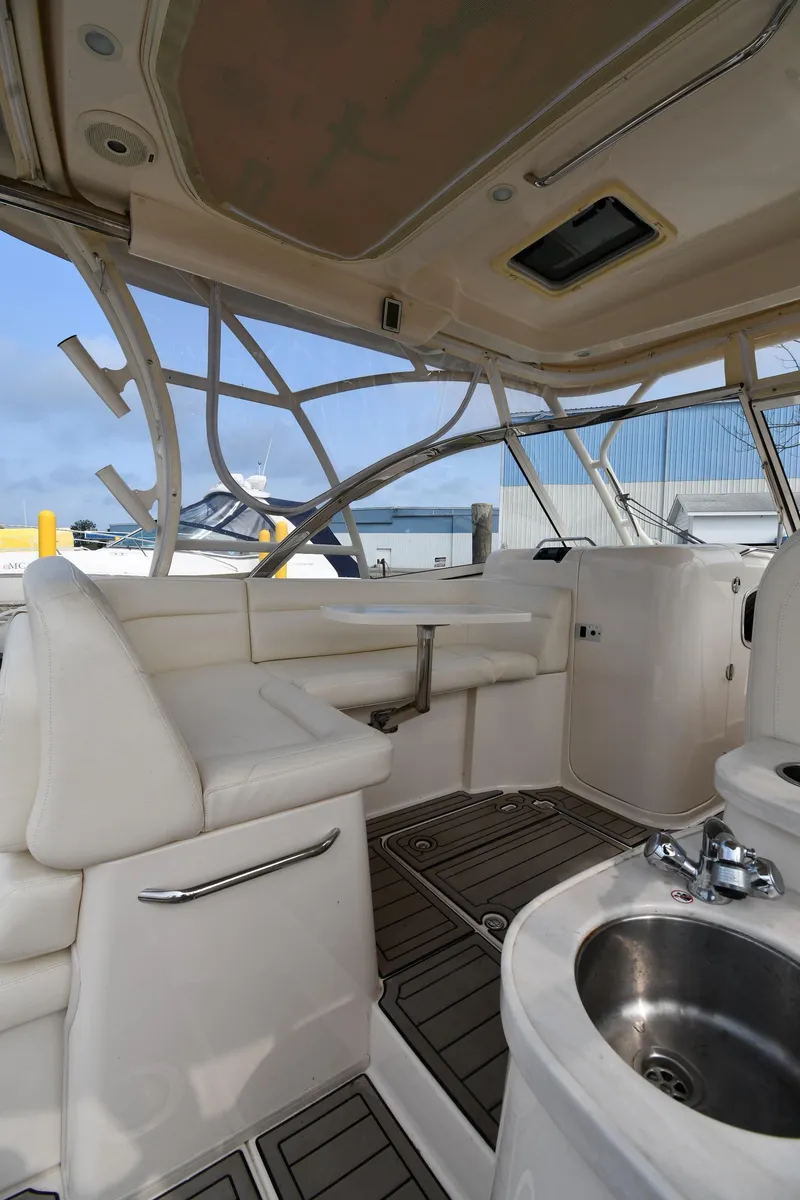Slide: The Image of 2018 Grady-White Freedom 335 boat interior with seating and sink, docked at marina. - 20