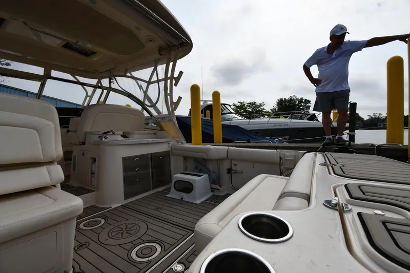Slide: The Image of 2018 Grady-White Freedom 335 boat interior with man on dock. - 21