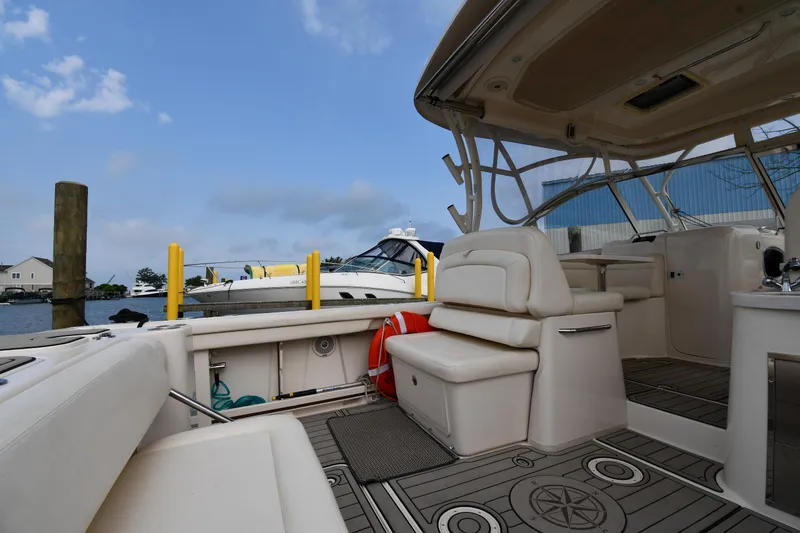 Slide: The Image of 2018 Grady-White Freedom 335 boat interior at dock, featuring seating and open deck. - 23