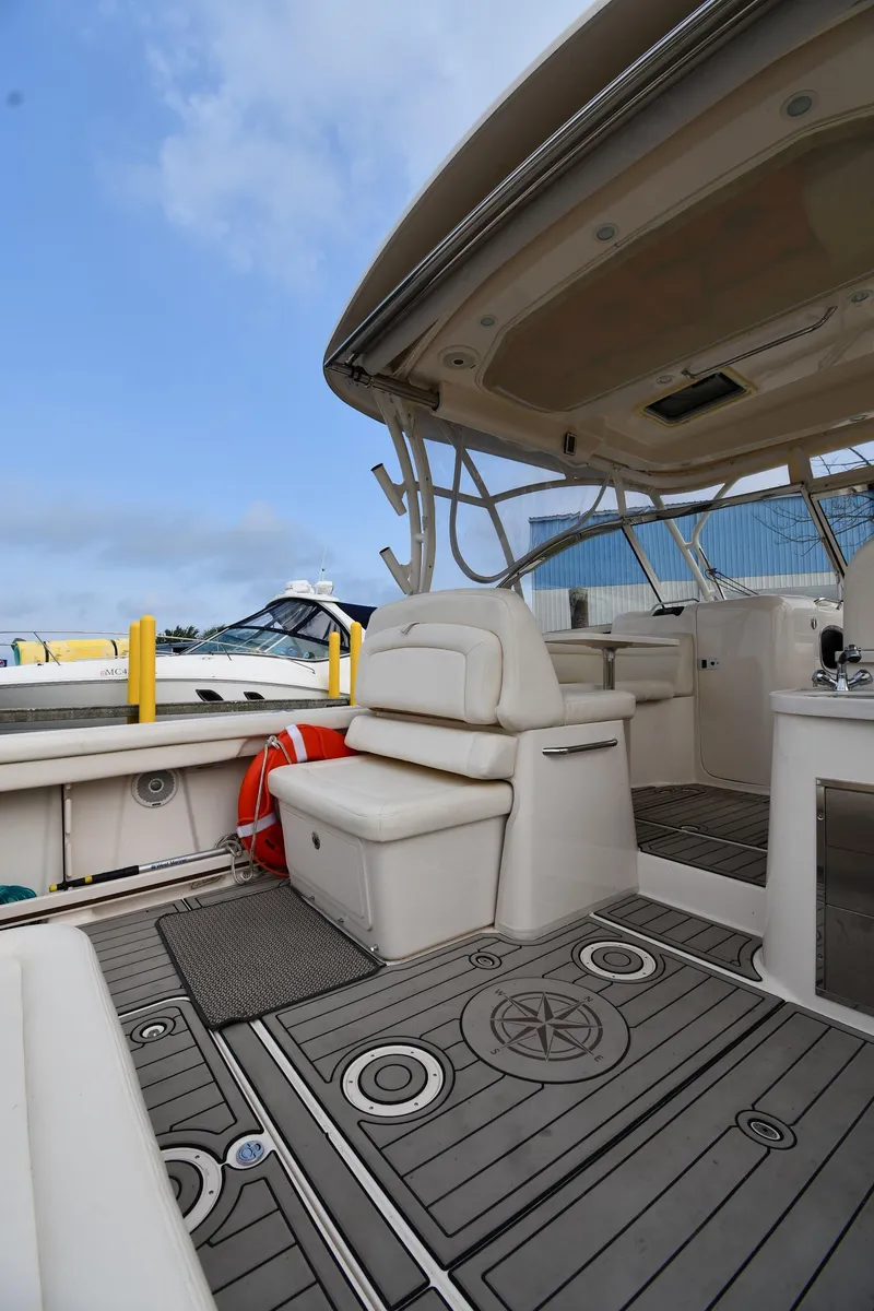 Slide: The Image of 2018 Grady-White Freedom 335 boat interior with seating and nautical-themed flooring. - 24