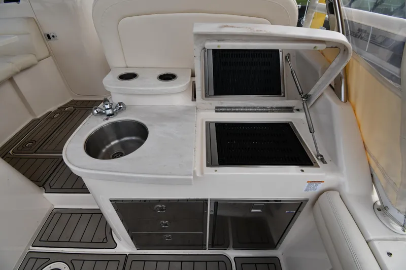 Slide: The Image of 2018 Grady-White Freedom 335 boat interior with sink and storage compartments. - 27