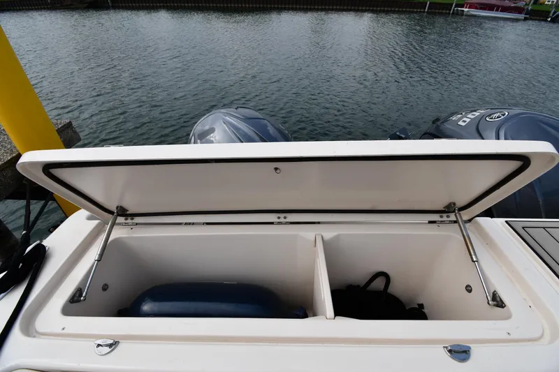 Slide: The Image of Open storage compartment on 2018 Grady-White Freedom 335 boat by the water. - 29