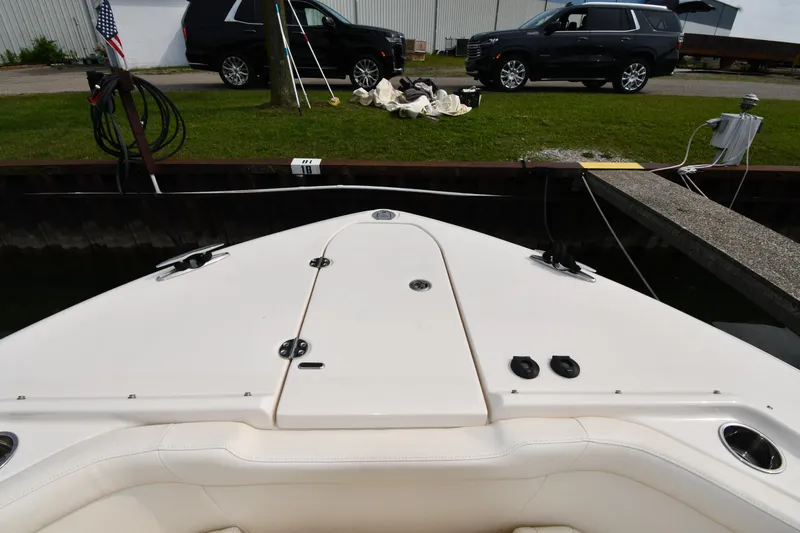 Slide: The Image of 2018 Grady-White Freedom 335 boat docked near parked SUVs. - 3