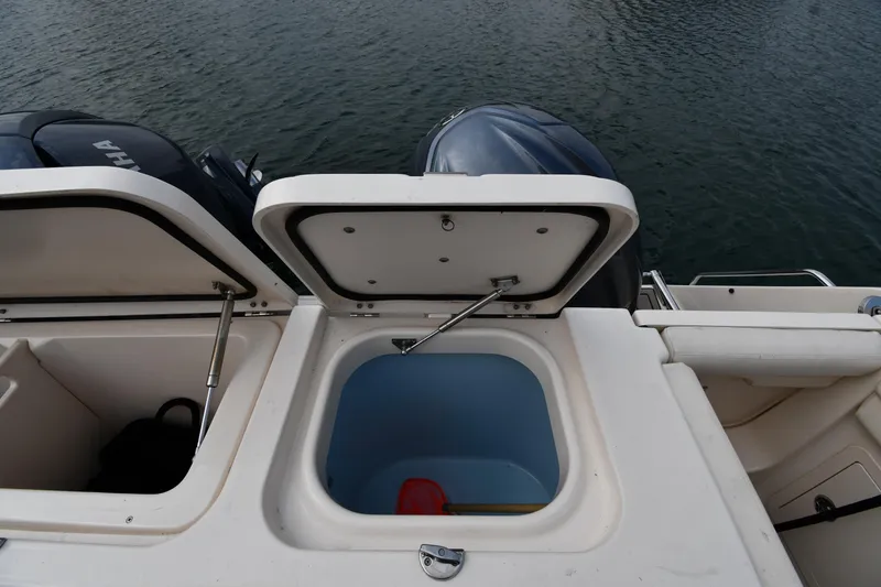 Slide: The Image of 2018 Grady-White Freedom 335 boat with open storage compartments and visible outboard motors. - 30