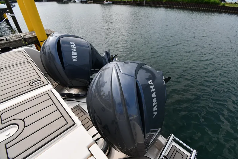 Slide: The Image of 2018 Grady-White Freedom 335 with Yamaha outboard engines docked by the water. - 32
