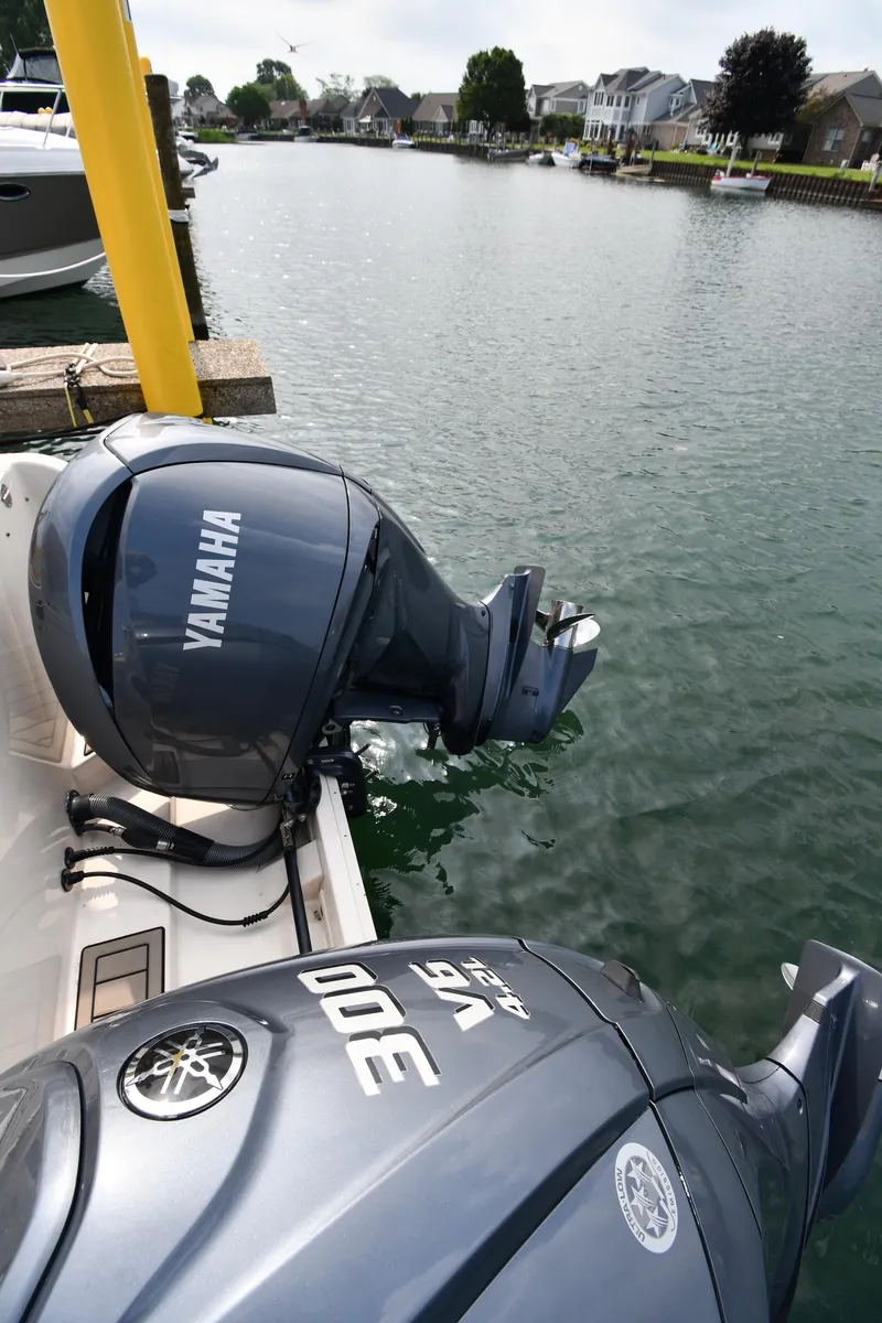 Slide: The Image of 2018 Grady-White Freedom 335 with Yamaha outboard engines docked by waterfront homes. - 33