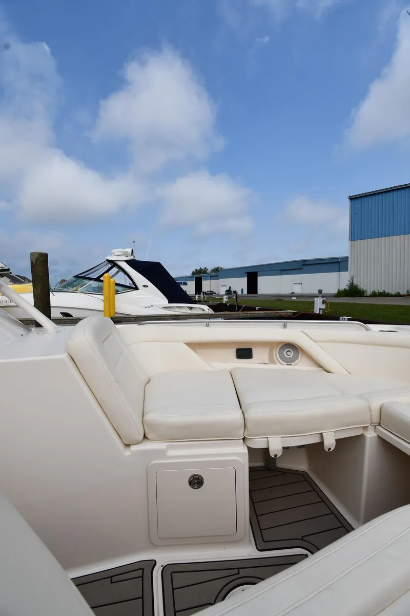 Slide: The Image of 2018 Grady-White Freedom 335 boat interior with white seating and blue sky background. - 38