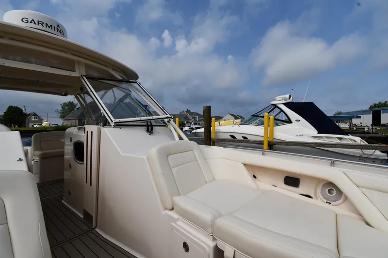 Slide: The Image of 2018 Grady-White Freedom 335 boat docked, featuring spacious seating and Garmin equipment. - 39