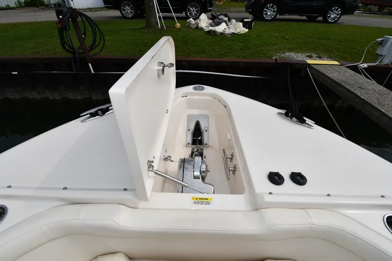 Slide: The Image of 2018 Grady-White Freedom 335 boat anchor compartment open at dock. - 4
