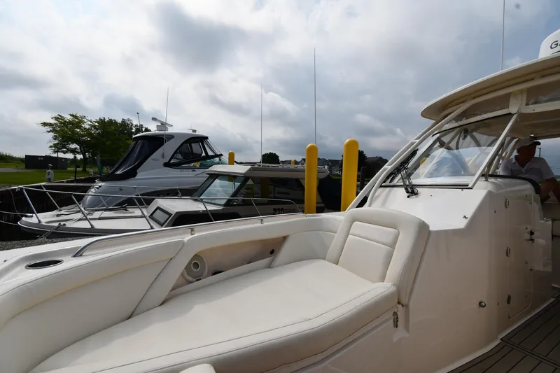 Slide: The Image of 2018 Grady-White Freedom 335 boat docked, featuring spacious seating and sleek design. - 40