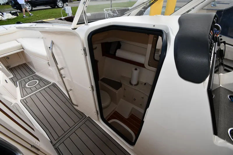 Slide: The Image of 2018 Grady-White Freedom 335 boat interior with open cabin door and visible amenities. - 42