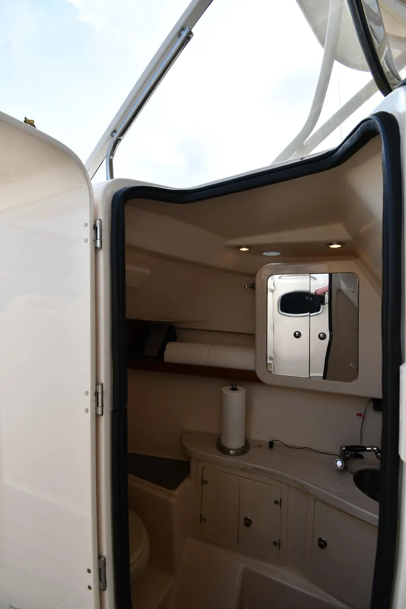 Slide: The Image of 2018 Grady-White Freedom 335 boat interior with compact bathroom amenities. - 43