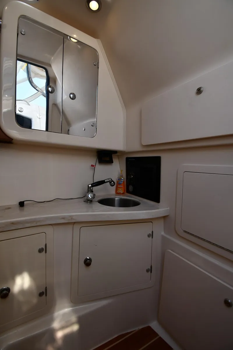 Slide: The Image of 2018 Grady-White Freedom 335 boat bathroom with sink, mirror, and storage cabinets. - 44