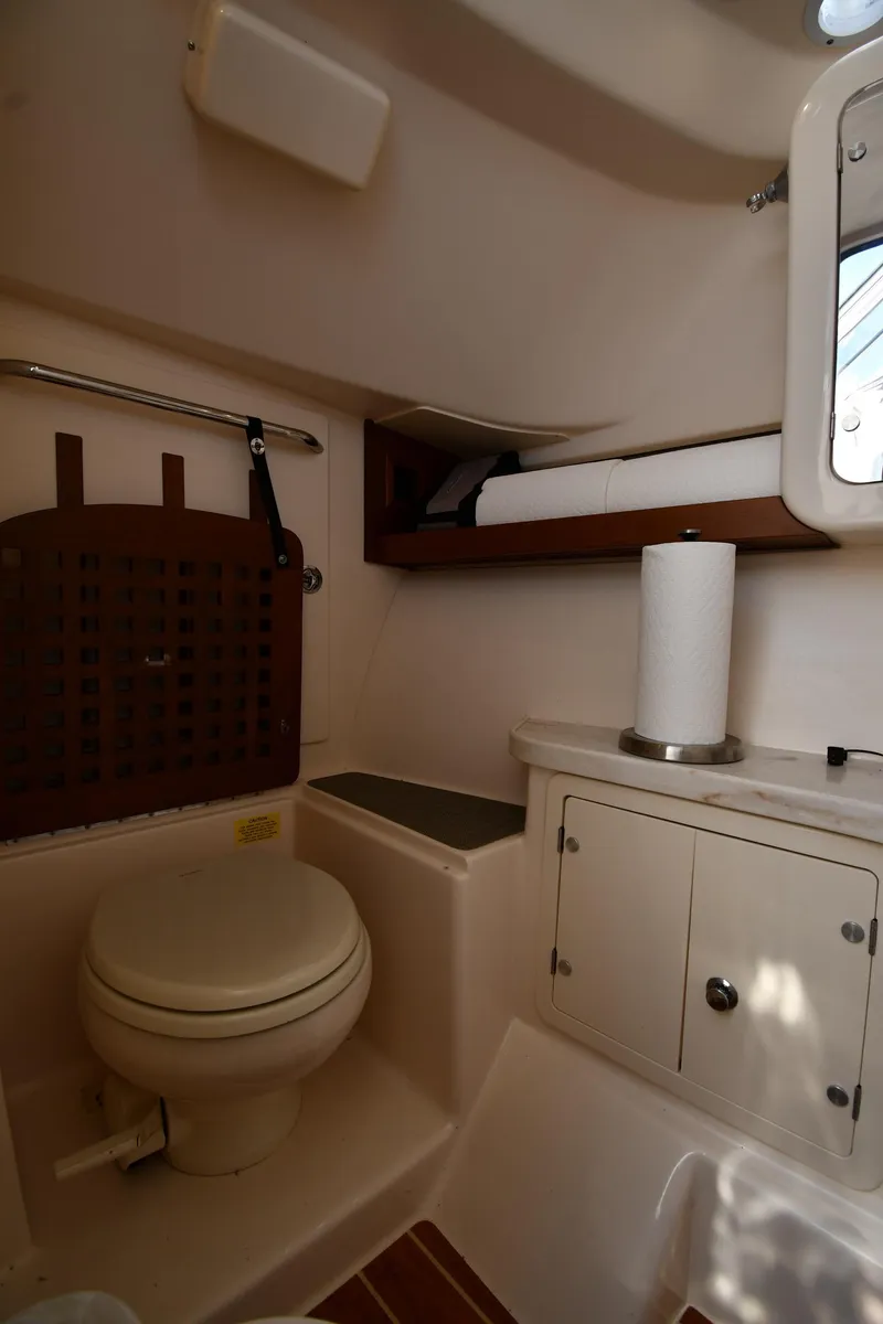 Slide: The Image of 2018 Grady-White Freedom 335 boat interior bathroom with toilet and storage cabinets. - 45