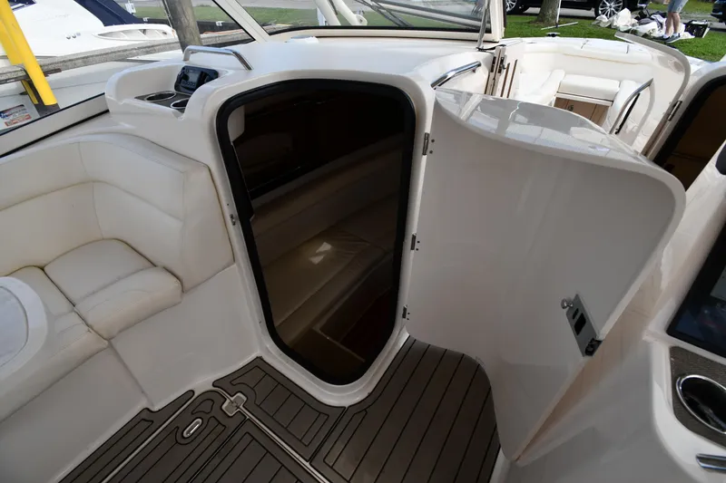 Slide: The Image of 2018 Grady-White Freedom 335 boat interior with open cabin door and seating area. - 46