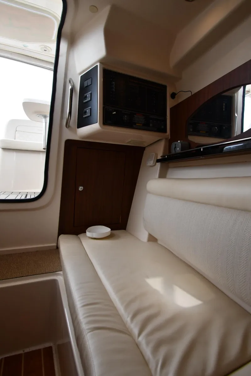 Slide: The Image of 2018 Grady-White Freedom 335 interior with cushioned seating and control panel. - 49