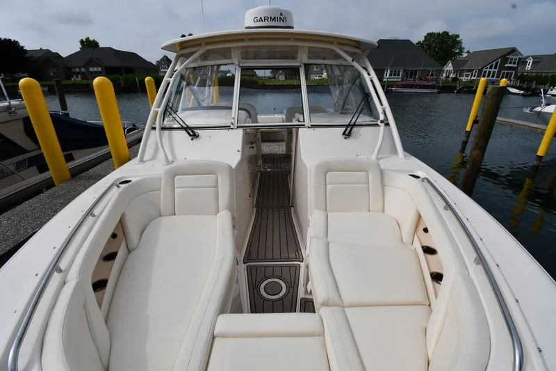 Slide: The Image of 2018 Grady-White Freedom 335 boat with spacious seating, docked in a marina. - 5