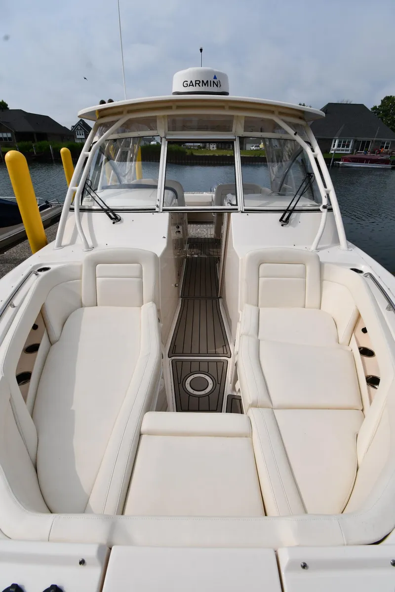 Slide: The Image of 2018 Grady-White Freedom 335 boat interior with white seating and Garmin equipment. - 6