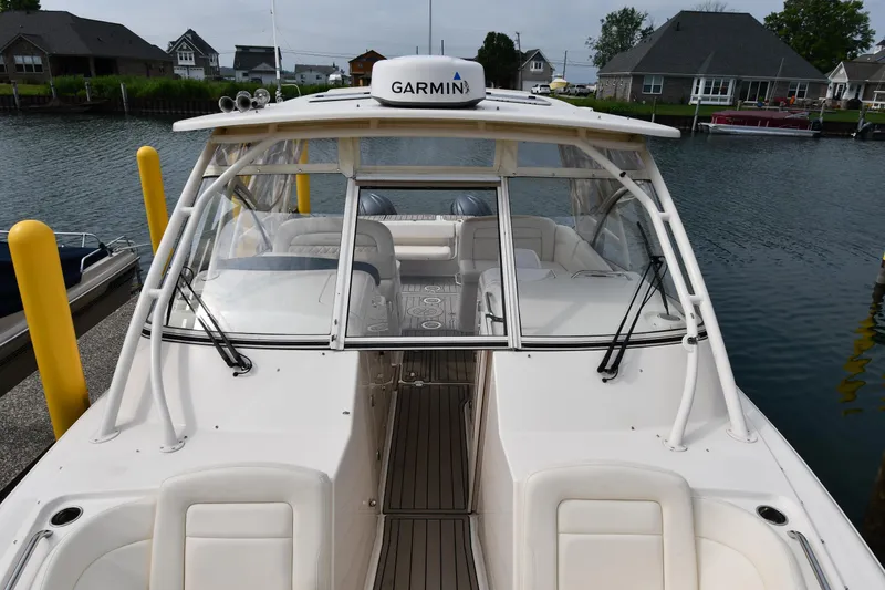 Slide: The Image of 2018 Grady-White Freedom 335 boat docked, featuring Garmin equipment and spacious seating. - 7