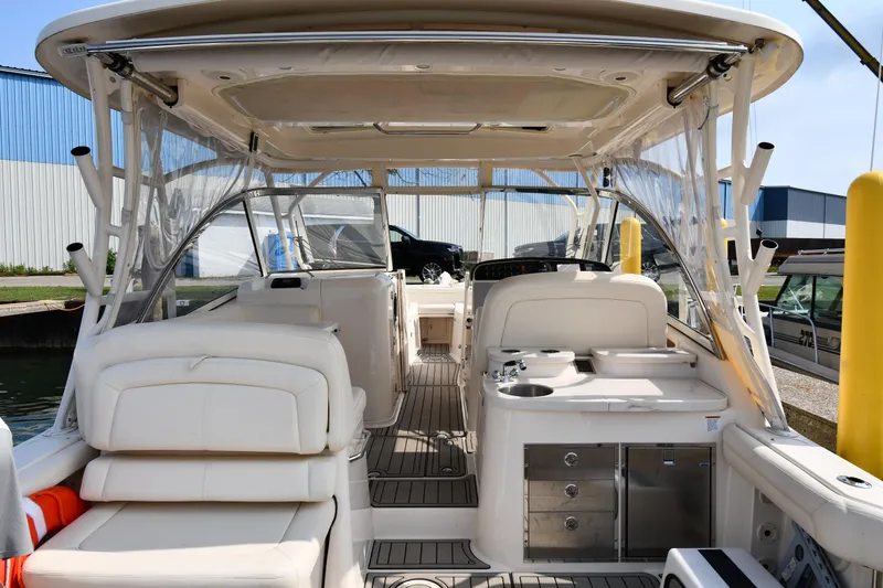 Slide: The Image of 2018 Grady-White Freedom 335 boat interior with seating and helm station. - 8