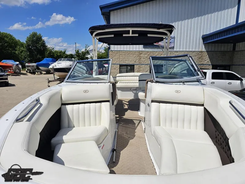Slide: The Image of 2015 Cobalt A28 boat with white interior, docked outdoors under a clear blue sky. - 10