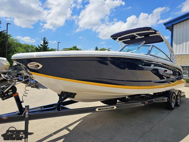 Slide: The Image of 2015 Cobalt A28 boat on trailer under blue sky. - 13