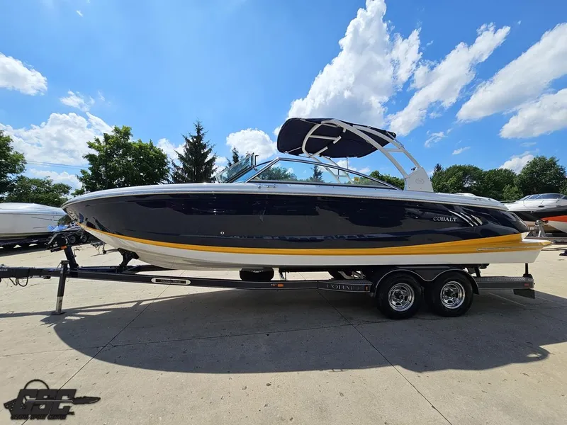 Slide: The Image of 2015 Cobalt A28 boat on trailer under blue sky with clouds. - 15