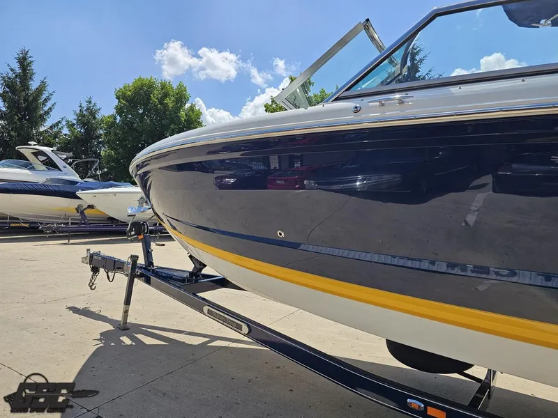 Slide: The Image of 2015 Cobalt A28 boat on trailer under clear blue sky. - 18