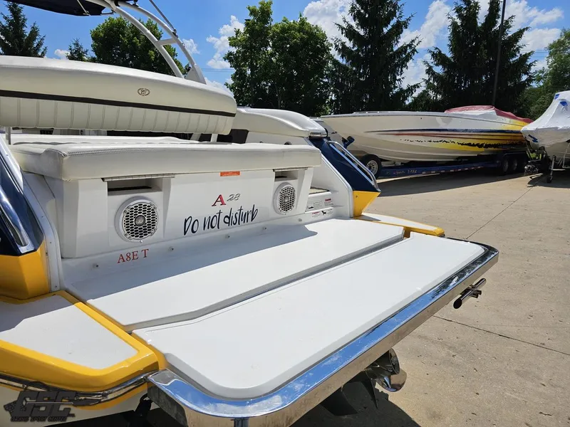Slide: The Image of 2015 Cobalt A28 boat with "Do not disturb" sign, docked outdoors under clear sky. - 23