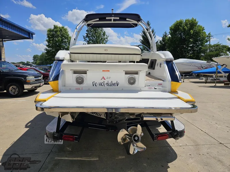 Slide: The Image of 2015 Cobalt A28 boat rear view with "Do not disturb" sign, parked outdoors. - 24